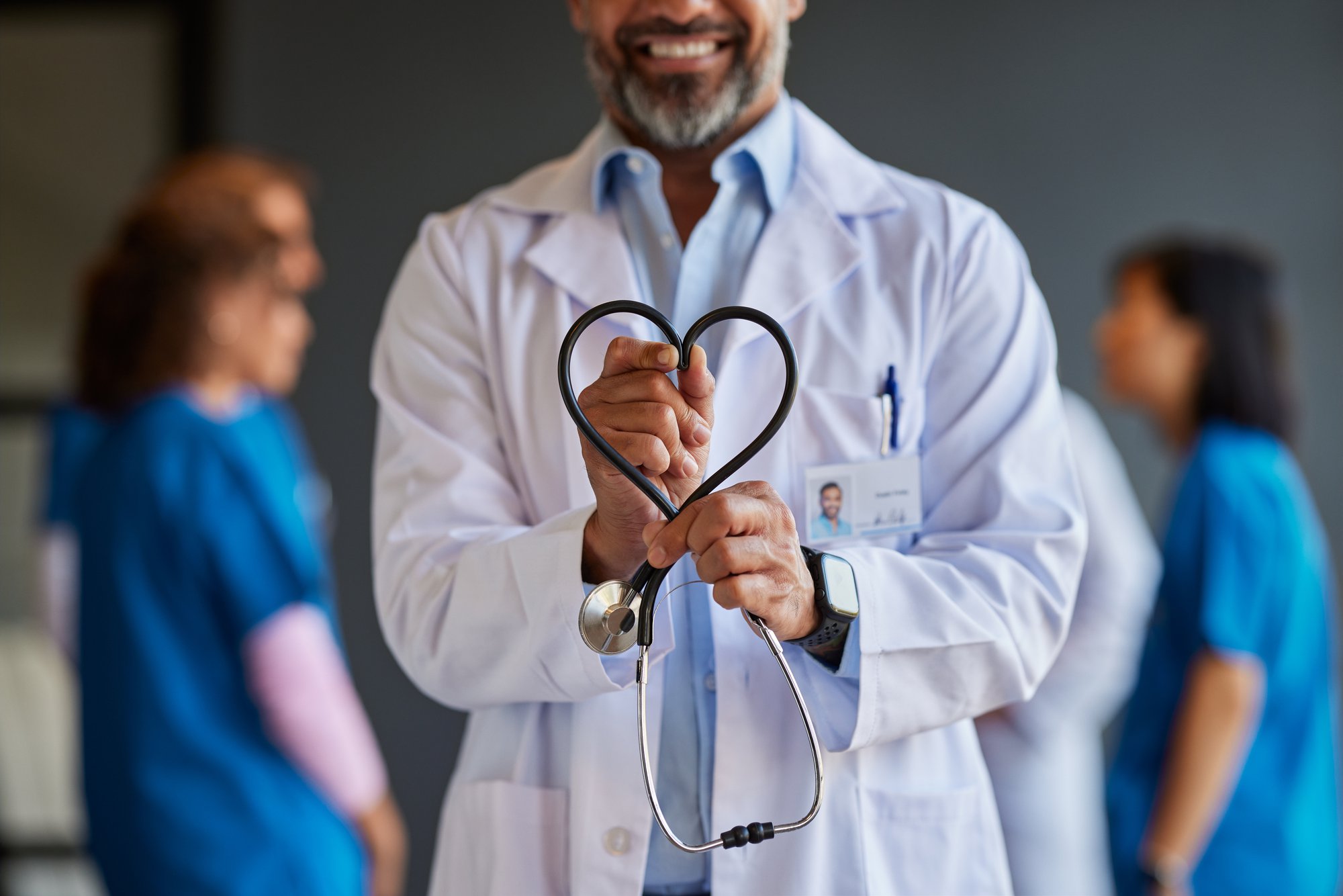 A doctor holding his heart-shaped stethoscope