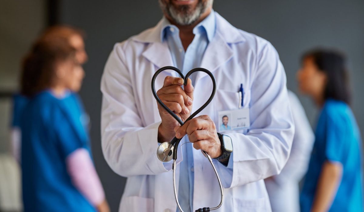 A doctor holding his heart-shaped stethoscope